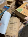 Stacks of worn-out books for sale at a used book fair in Vietnam, May 2022
