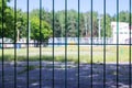 Stadium behind a blue mesh fence close up Royalty Free Stock Photo