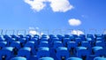 Old stadium blue benches with a blue sky in background Royalty Free Stock Photo