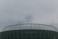 Stadium building against a rainy sky