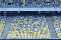 Stadium. Empty seats on stands painted blue and yellow colors Royalty Free Stock Photo