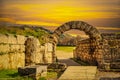 Stadium entrance  - Stone walls and arch entering the field where first olympics took place in Olympia Greece at sunset Royalty Free Stock Photo