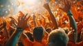 The stadium erupts in a sea of orange as fans jump to their feet to celebrate a winning goal