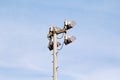 Stadium floodlight tower with reflectors with blue sky background