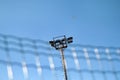 Stadium floodlight tower with reflectors with blue sky background