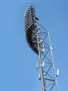 Stadium floodlights against blue sky