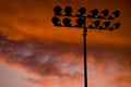 Stadium floodlights at sunset