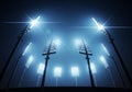 A stadium illuminated by eight tall floodlights against a dark night sky. The lights are arranged Royalty Free Stock Photo