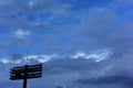 A stadium light stand is silhouetted against dark and cloudy sky. Royalty Free Stock Photo