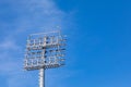 Stadium lighting system on background of blue sky. Royalty Free Stock Photo
