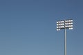 Stadium lights on a blue sky background