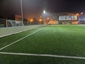 Stadium in lights and flashes. Empty beautiful football field with glowing spotlights in the evening or at night. Artificial turf Royalty Free Stock Photo