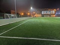 Stadium in lights and flashes. Empty beautiful football field with glowing spotlights in the evening or at night. Artificial turf Royalty Free Stock Photo