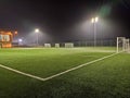 stadium in lights and flashes. Empty beautiful football field with glowing spotlights in the evening or at night Royalty Free Stock Photo