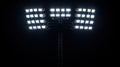 Stadium lights illuminating dark night sky powerful floodlights shining brightly Royalty Free Stock Photo