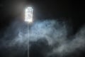 Stadium lights and smoke against dark night sky Royalty Free Stock Photo