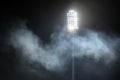 Stadium lights and smoke against dark night sky Royalty Free Stock Photo