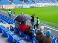 At the stadium before the match. Half empty stadium. The fans haven't arrived yet. Football stewards. Waiting for a football