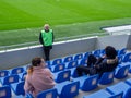 At the stadium before the match. Half empty stadium. The fans haven't arrived yet. Football stewards. Waiting for a football