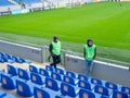 At the stadium before the match. Half empty stadium. The fans haven't arrived yet. Football stewards.