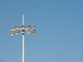Stadium spotlight with ten lights standing against blue sky day. Royalty Free Stock Photo