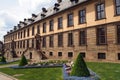Stadtschloss, manicured flowerbed and evergreen trees in the front court, Fulda, Germany