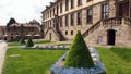 Stadtschloss, manicured flowerbed and evergreen trees in the front court, Fulda, Germany