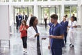 Staff In Busy Lobby Area Of Modern Hospital