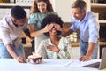 Staff Celebrating Birthday Of Female Colleague In Architects Office With Cake