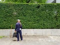 The staff cleaning the garden and leaves fall on the road with copy space