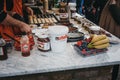 Staff cooking Dutch pancakes at a stall inside Camden Market, London, UK