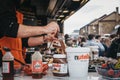 Staff cooking Dutch pancakes at a stall inside Camden Market, London, UK