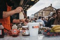 Staff cooking Dutch pancakes at a stall inside Camden Market, London, UK