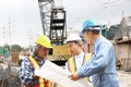 Staff engineer bored pile team planning work in construction site. group of engineers consulting problem work on site