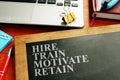 Staff hire, train, motivate and retain written on blackboard