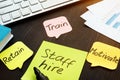 Staff hire, train, motivate and retain written on memo sticks