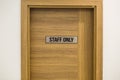 Staff only, the inscription on the door. Wooden textured door