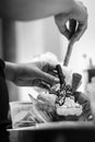 Staff making italian gelato ice cream sundae in modern shop