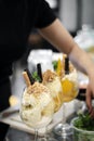 Staff making italian gelato ice cream sundae in modern shop