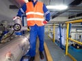 Staff man checks the valves on high pressure biogas stainless steel pipes Royalty Free Stock Photo