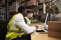 Staff managing warehouse logistics in an on-site office Royalty Free Stock Photo