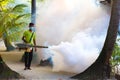 Staff member of Medhufushi Island Resort spraying garden in Maldives. Royalty Free Stock Photo