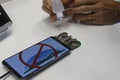 A staff member shows to visitors how to seal their mobile phones at MWC19 in Barcelona