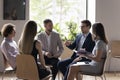 Staff members communicating during corporate briefing in office Royalty Free Stock Photo