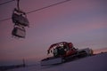 Tractor cleaning snow on the ski slopes in the Alps Royalty Free Stock Photo