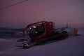 Tractor cleaning snow on the ski slopes in the Alps Royalty Free Stock Photo