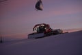 Tractor cleaning snow on the ski slopes in the Alps Royalty Free Stock Photo