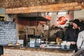 Staff at Roadkill street food stand inside Camden Market, London, UK Royalty Free Stock Photo