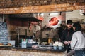 Staff at Roadkill street food stand inside Camden Market, London, UK Royalty Free Stock Photo