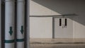 staff room door with blurred water pipe system lines outside of building in foreground